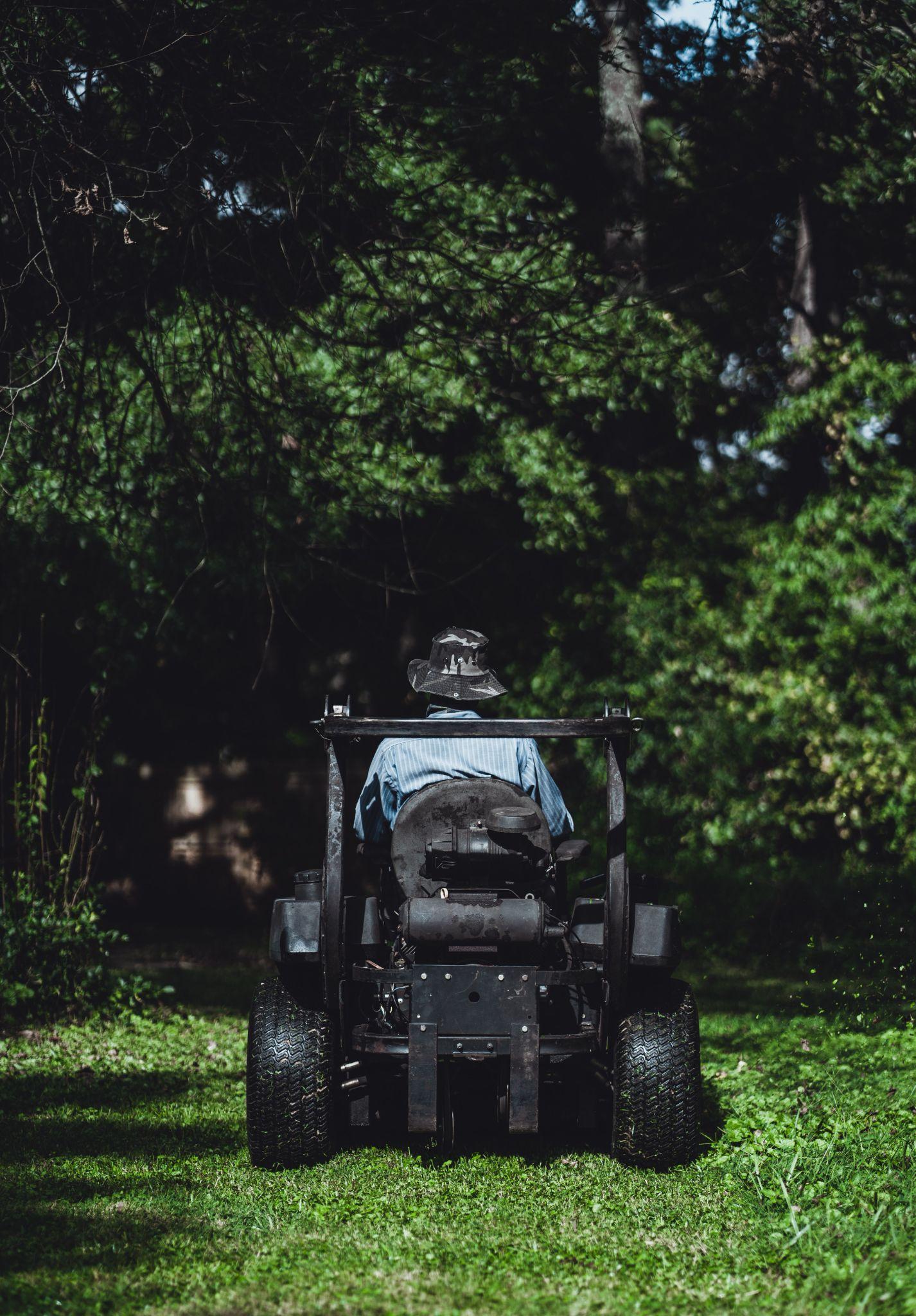 Residential lawn being mowed at a taller height